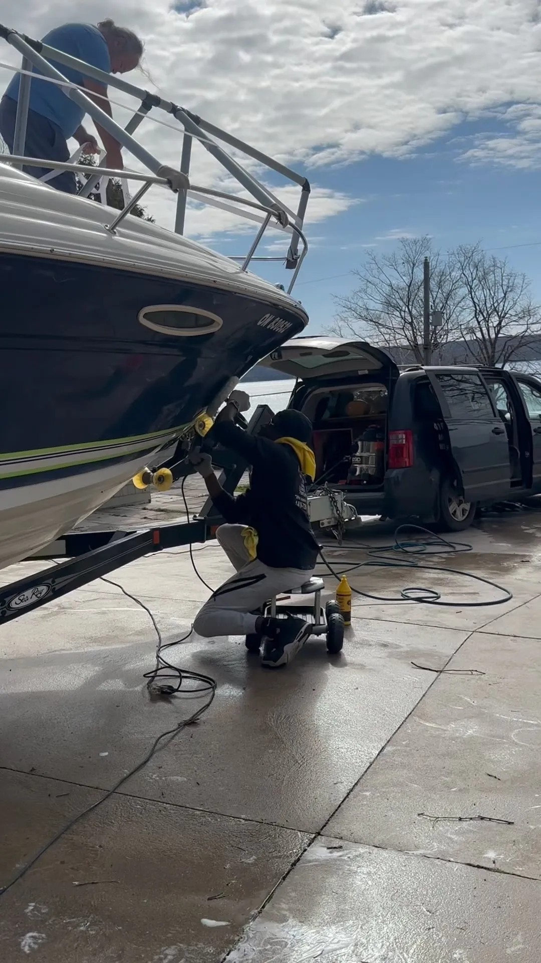 Machine polishing a boat hull on its trailer